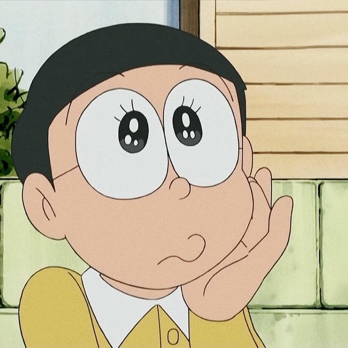 Nobita chống cằm suy tư mơ mộng bên cửa sổ
